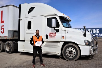 Student standing near a truck with experience certificate